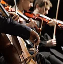 3 people playing violins